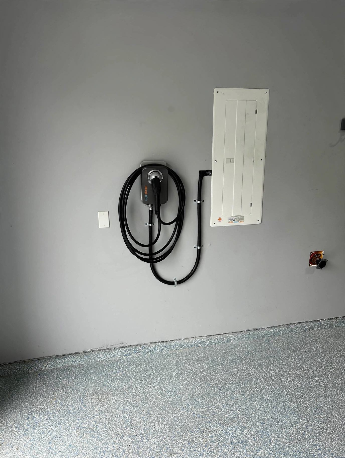 ChargePoint Level 2 charger mounted beside the electrical panel in an Abbotsford garage